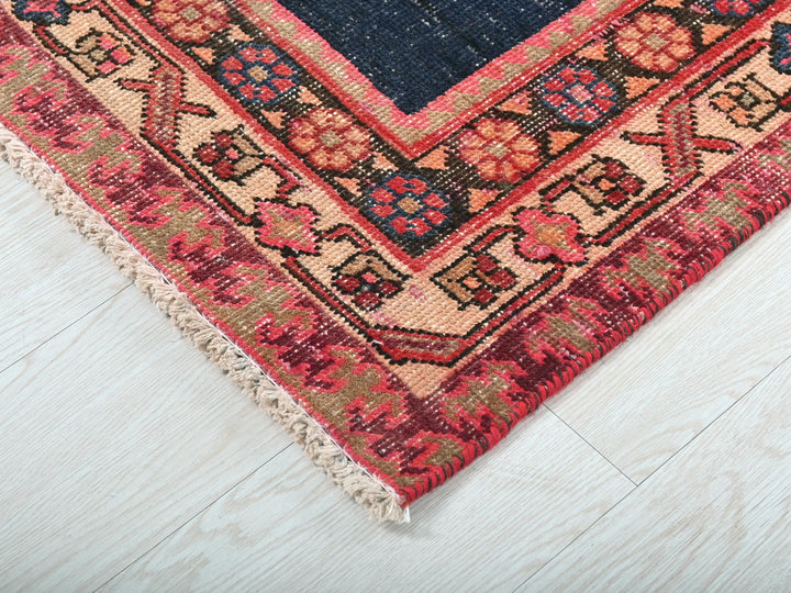 a blue and red rug on a white floor