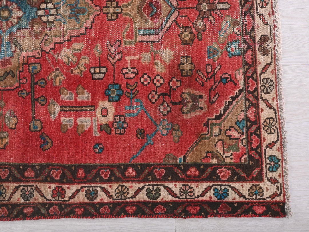 a red oriental rug on a white background