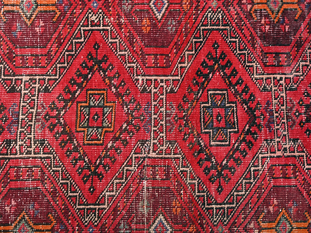 a close up of a red and black rug