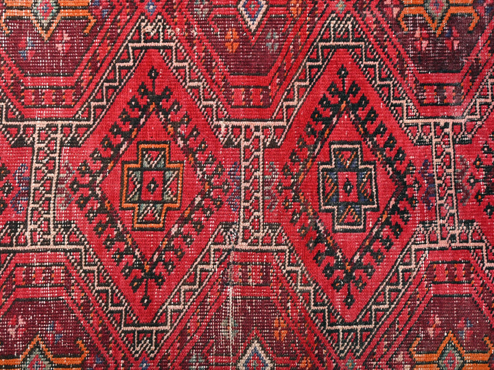 a close up of a red and black rug