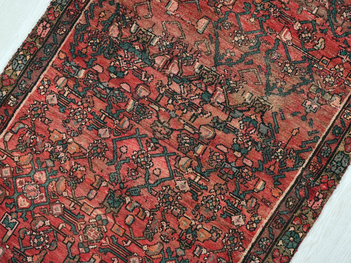 a red rug with a design on the middle of it