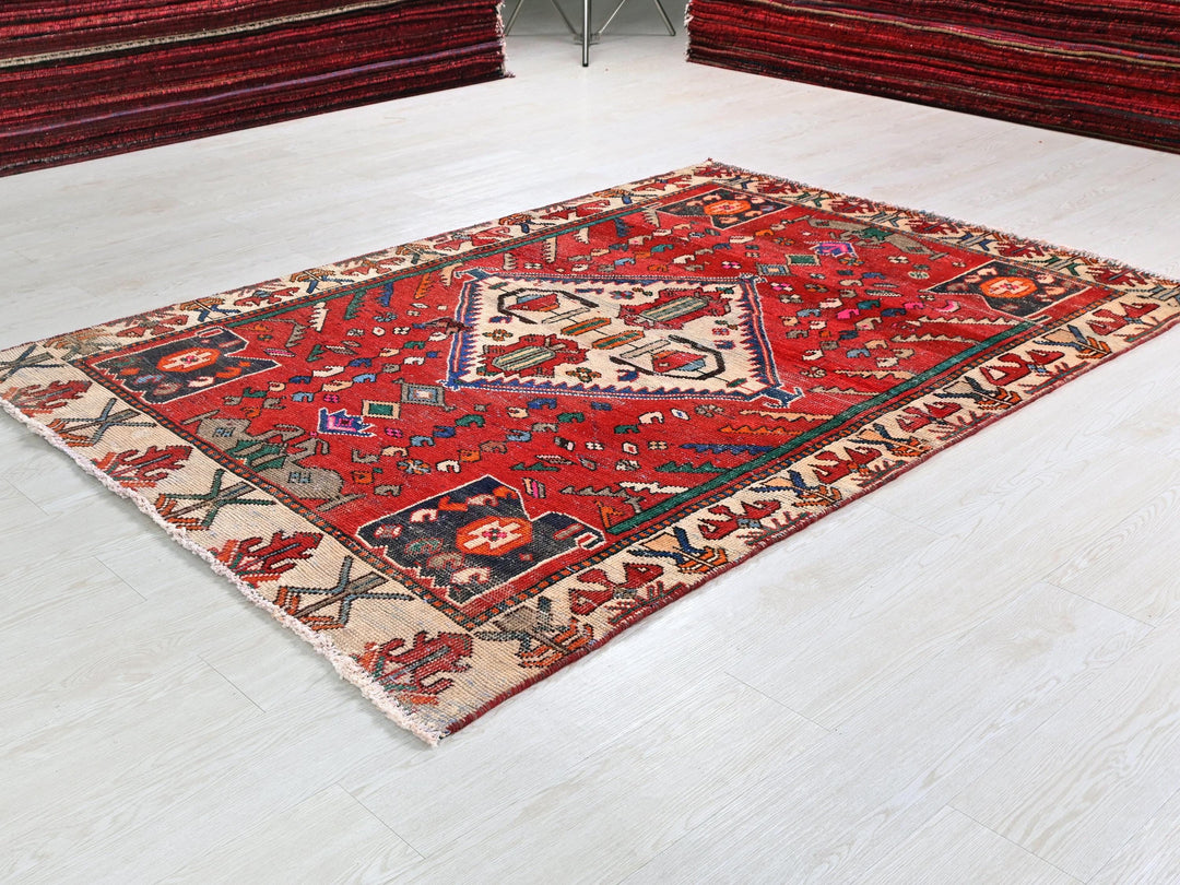 a red rug is on the floor of a room