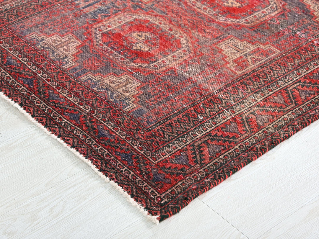 a red and blue rug on a white floor