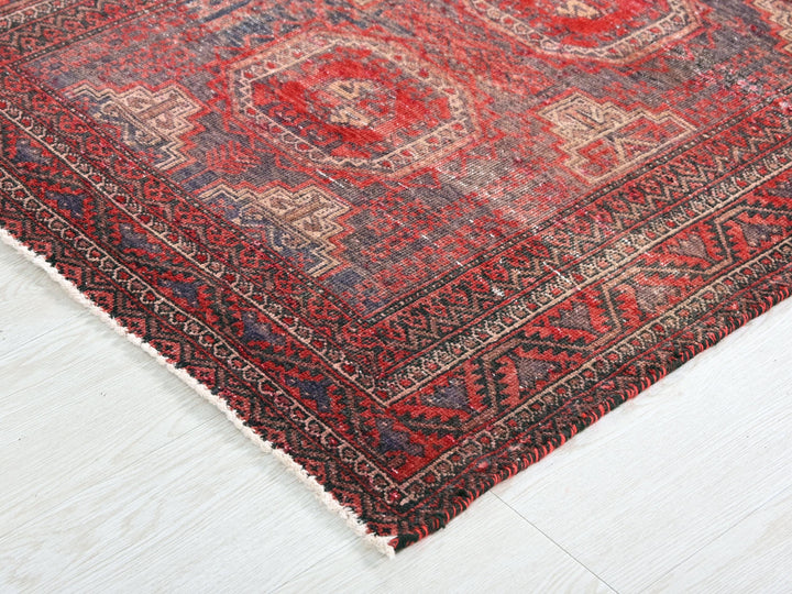 a red and blue rug on a white floor