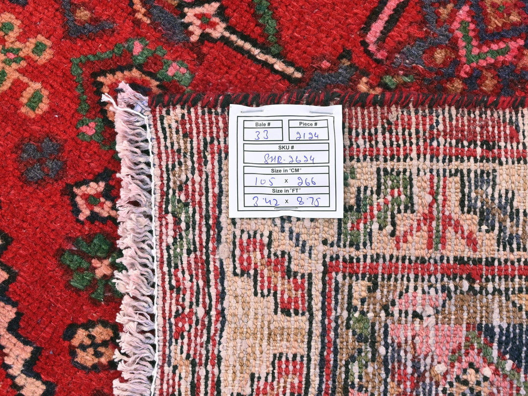 a pile of red and blue rugs with numbers on them