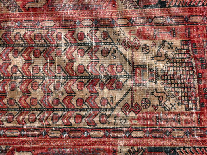 a red and black rug with a design on it