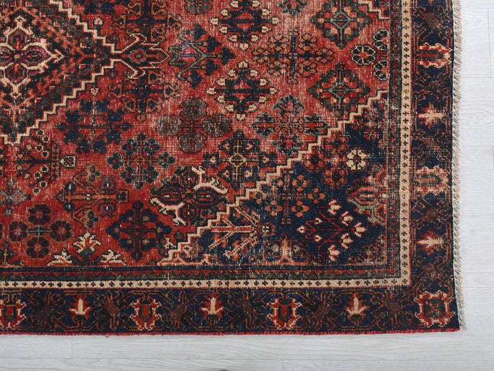 a red and blue rug on a white floor