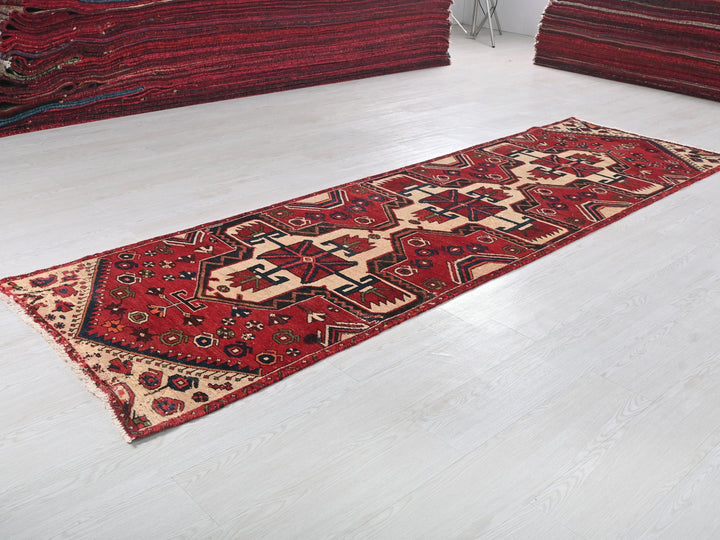 a red rug is laying on a white floor