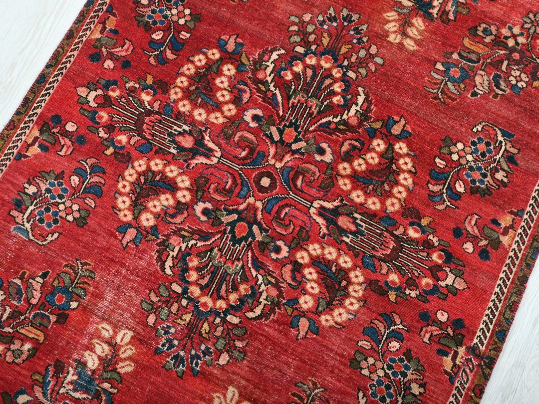 a red rug with a floral design on it