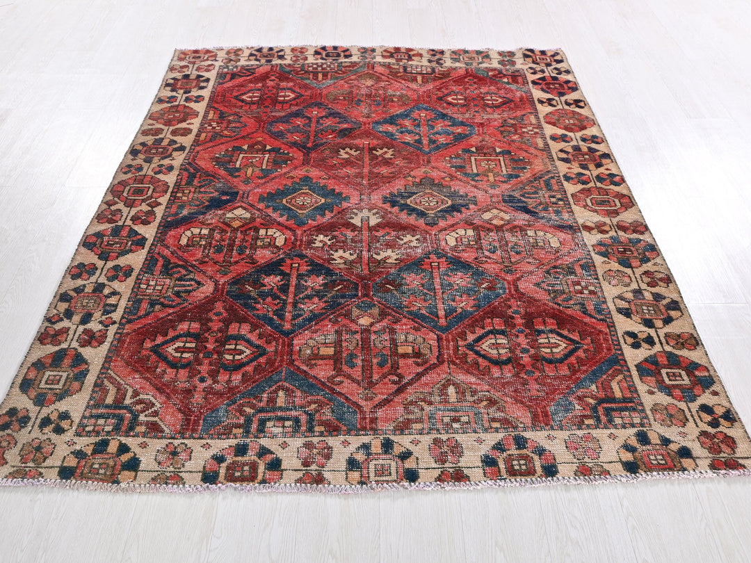 a red and blue rug on a white floor