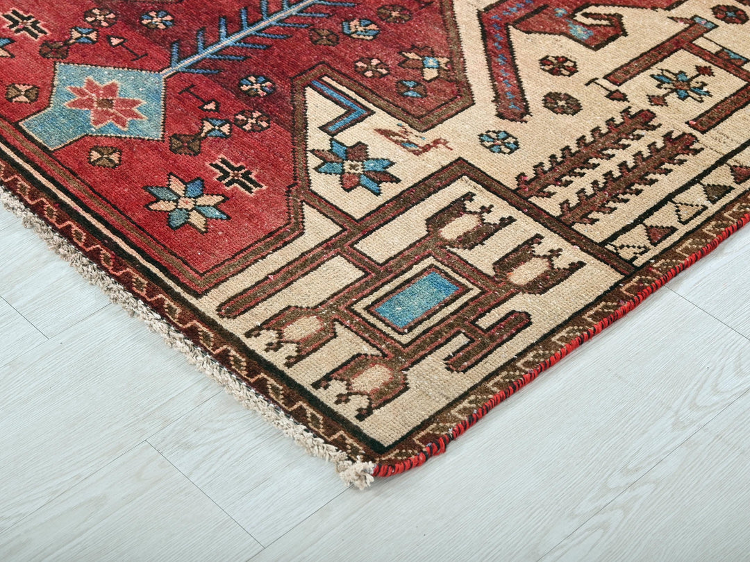 a red rug with a design on it