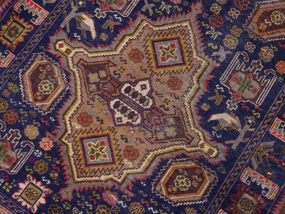 a close up of an oriental rug with a blue background