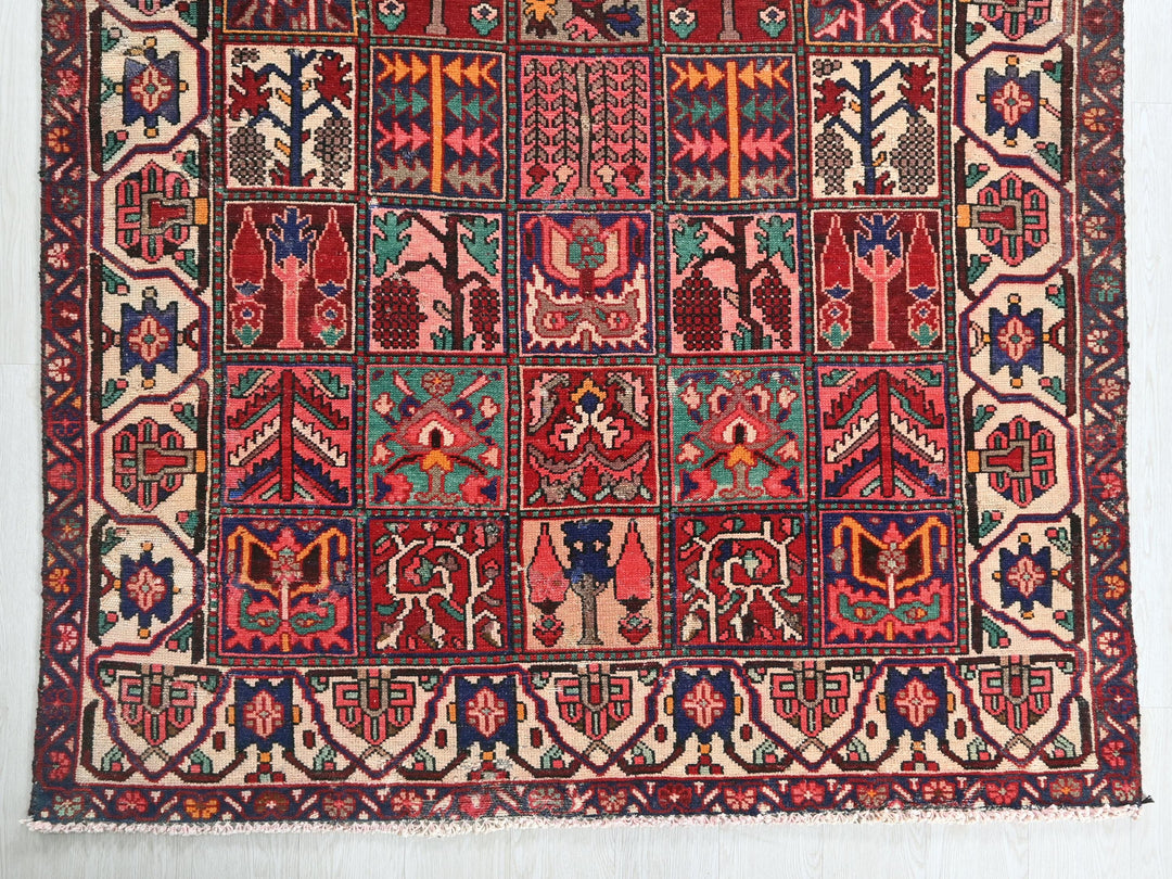 a red and blue rug hanging on a wall