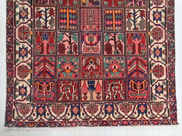 a red and blue rug hanging on a wall