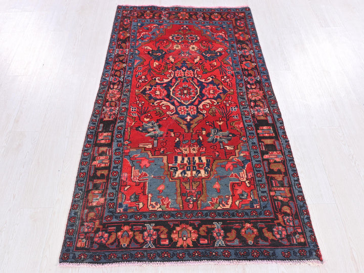 a red and blue rug on a white floor