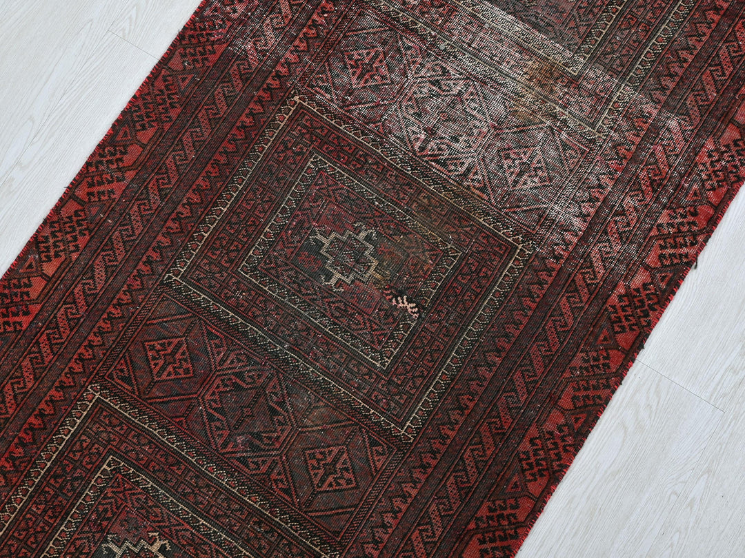 a red oriental rug on a white floor