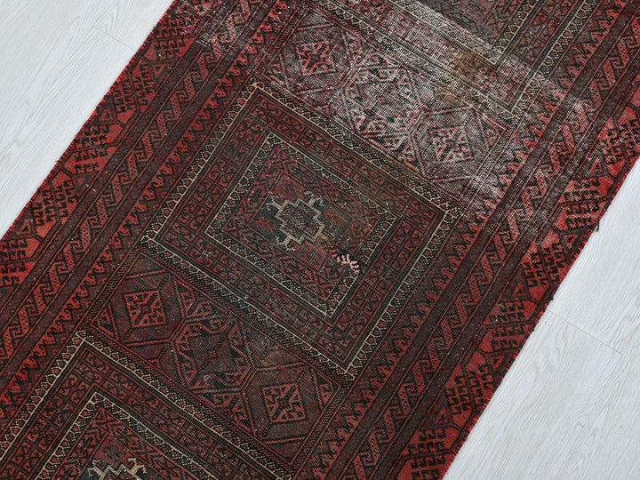 a red oriental rug on a white floor