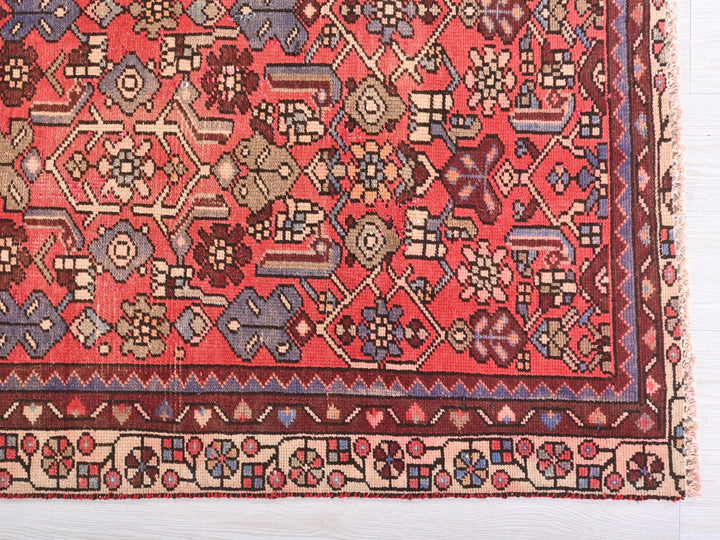 a red and blue rug with a design on it