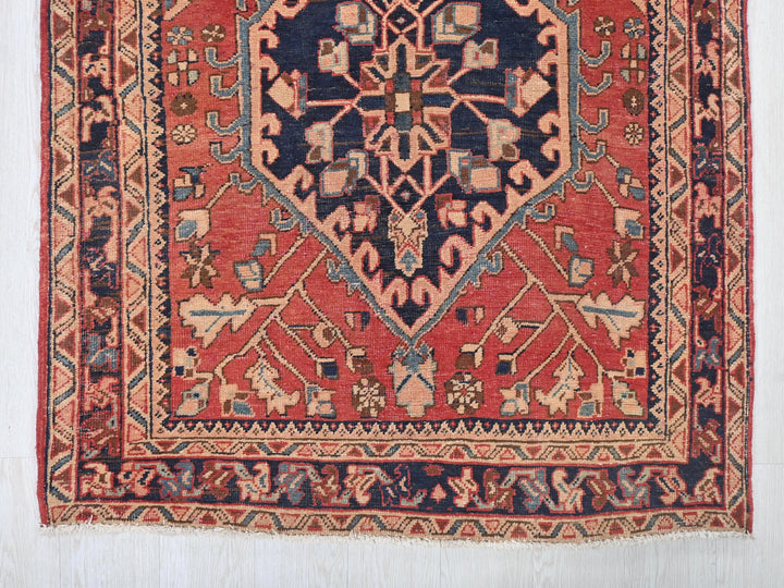a red rug with a blue design on it