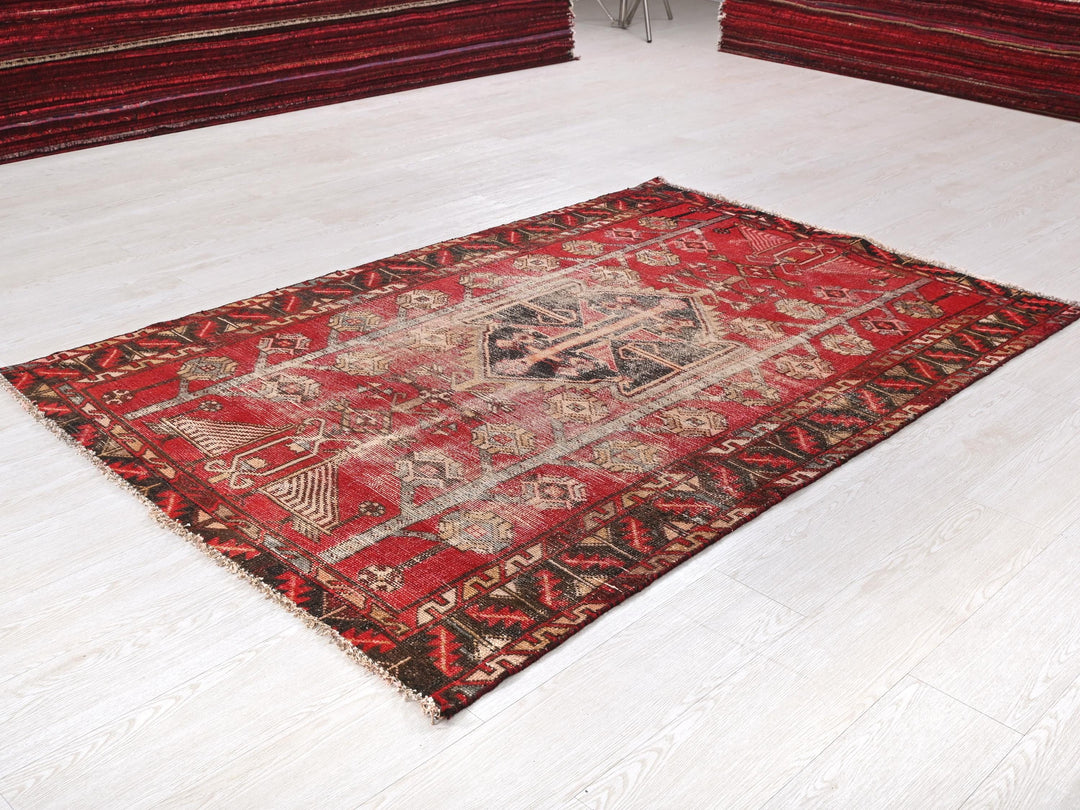 a red rug on the floor of a room