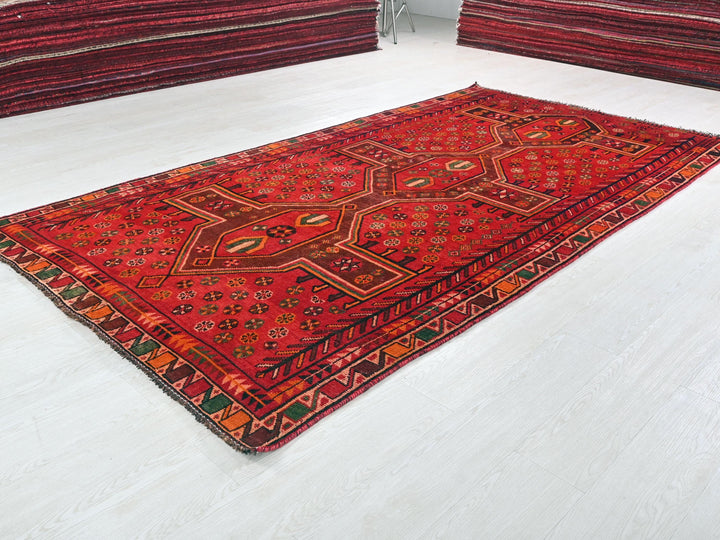 a red rug is laying on the floor