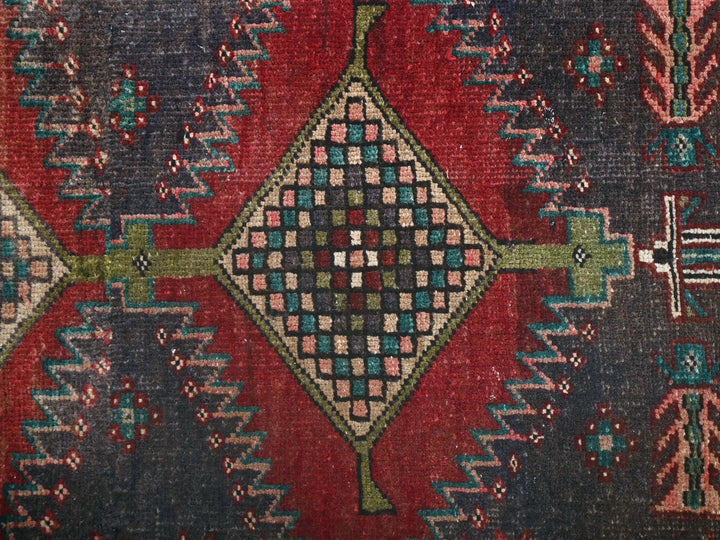 a red and blue rug with a design on it