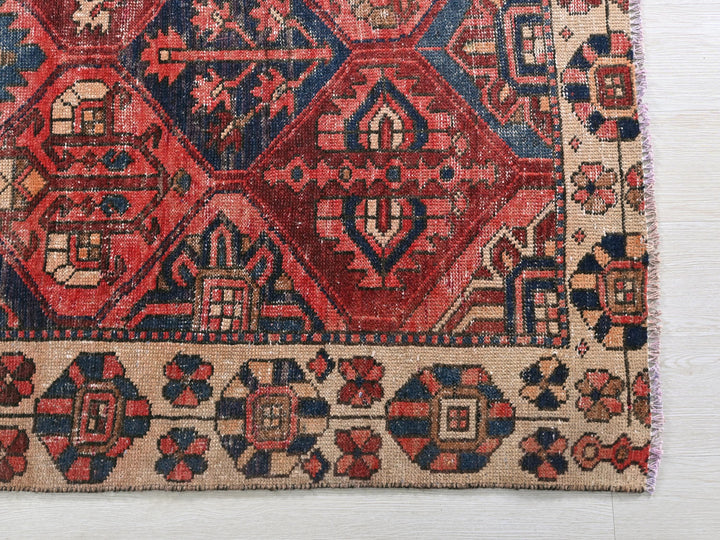 a red and blue rug on a white floor