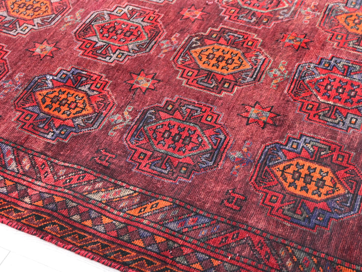 a red rug with a pattern on it