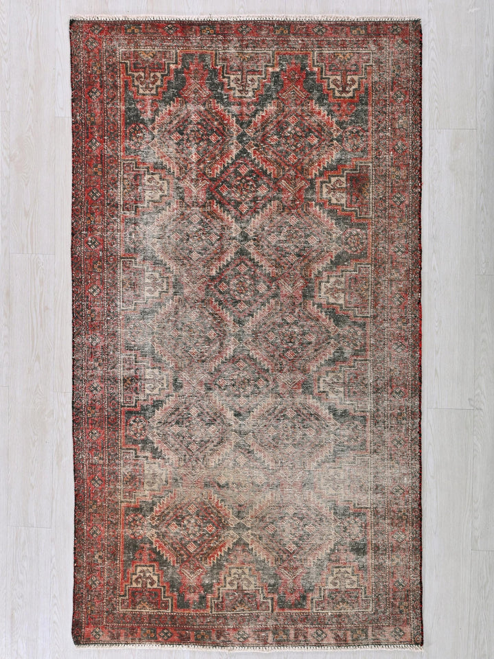 a red and blue rug on a white wall