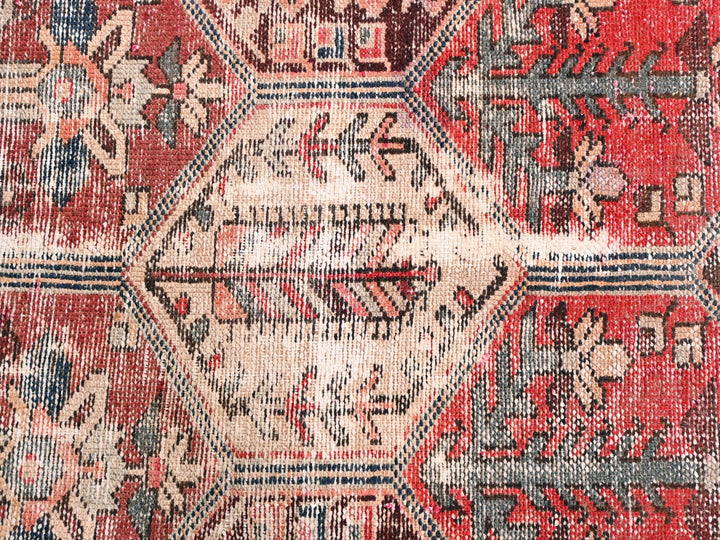a close up of a red and blue oriental rug