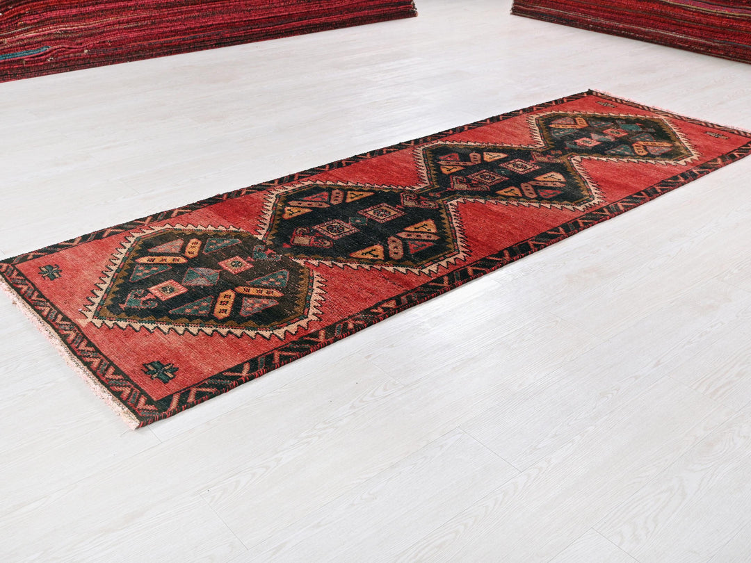 a red rug on the floor of a room