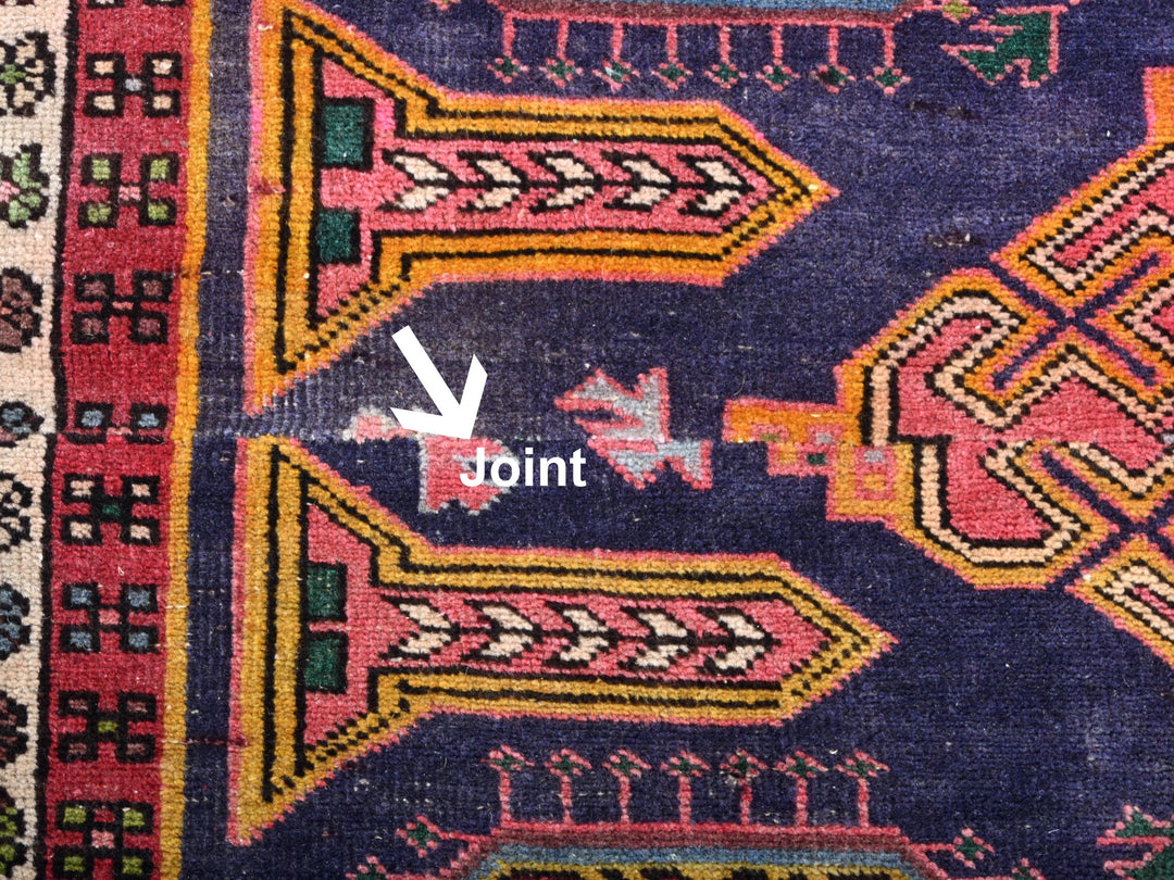 a close up of a colorful rug with a white arrow pointing to it