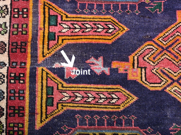 a close up of a colorful rug with a white arrow pointing to it
