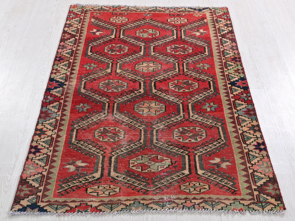 a red rug with a diamond pattern on it