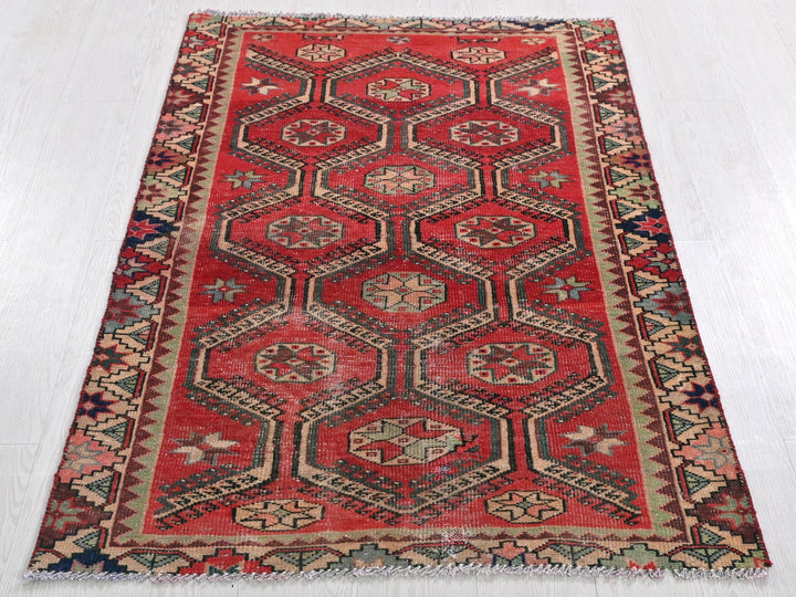 a red rug with a diamond pattern on it