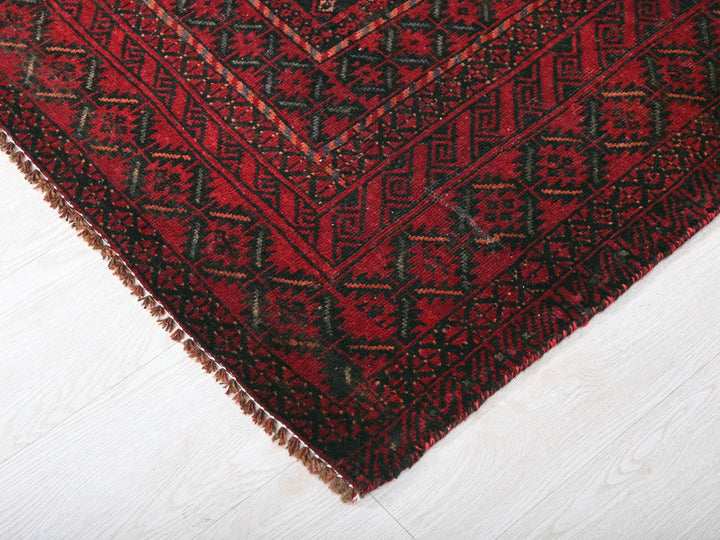 a close up of a red rug on a white floor