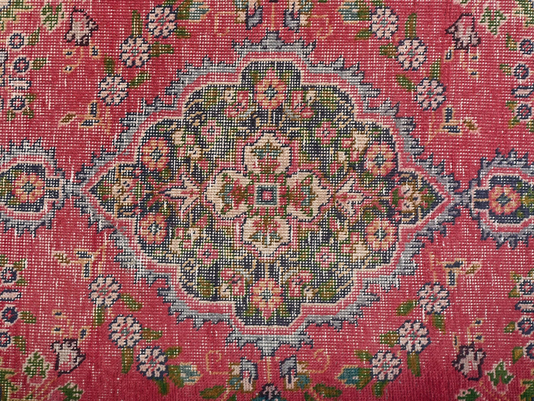a close up of a rug with a red background