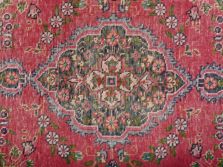 a close up of a rug with a red background