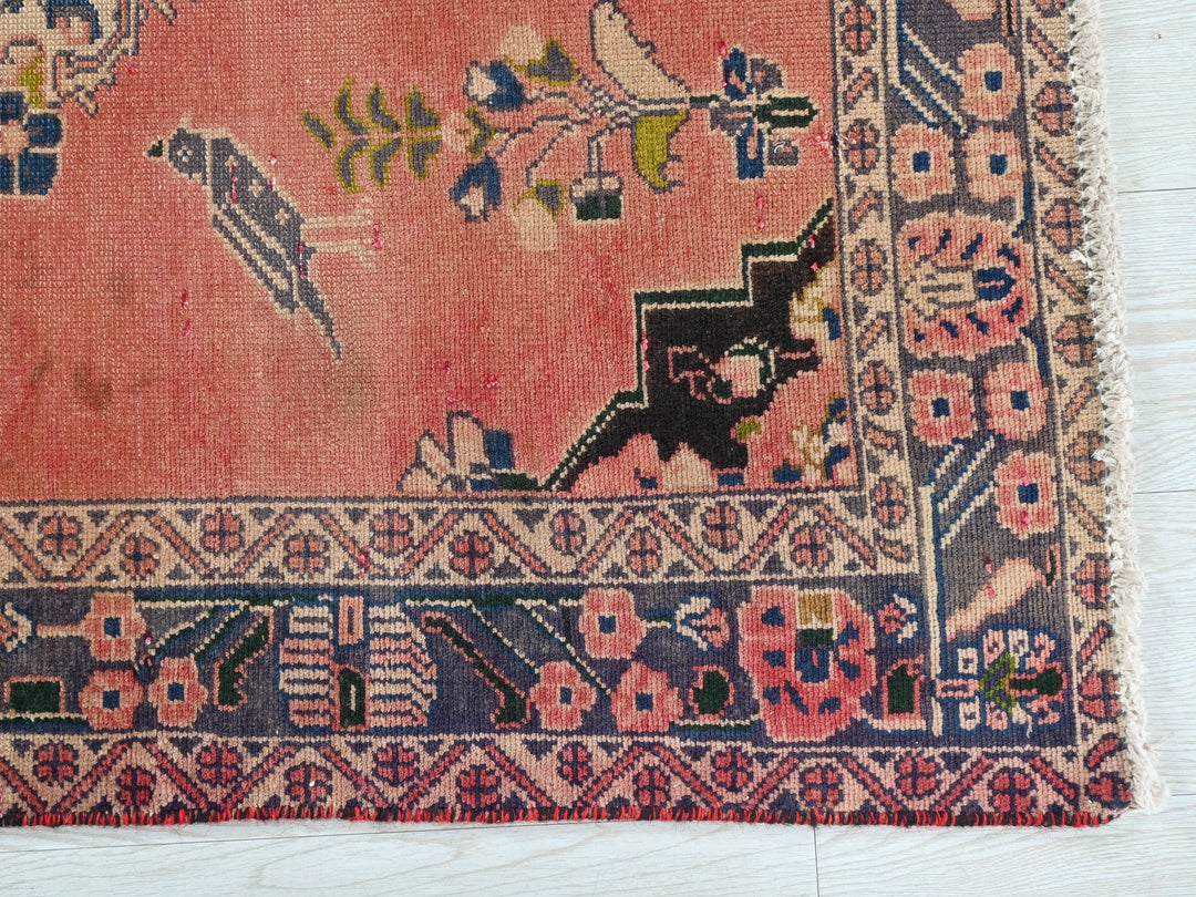 a pink rug with a black cat on it