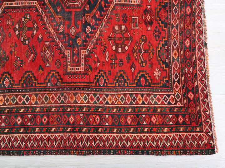 a red rug with a design on it