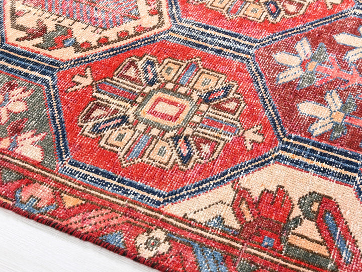 a close up of a red rug with a pattern on it