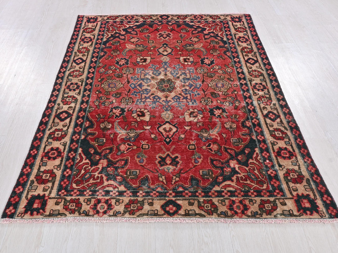 a red and blue rug on a white floor