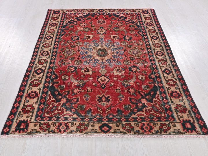 a red and blue rug on a white floor