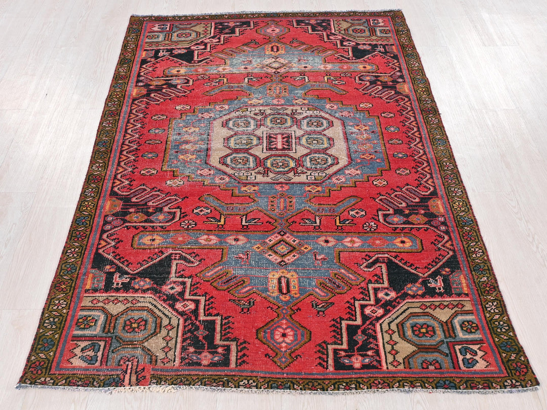 a red rug with a blue and red design on it