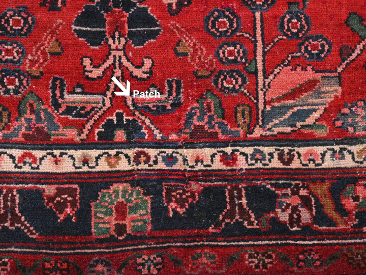 a close up of a red rug with a black border