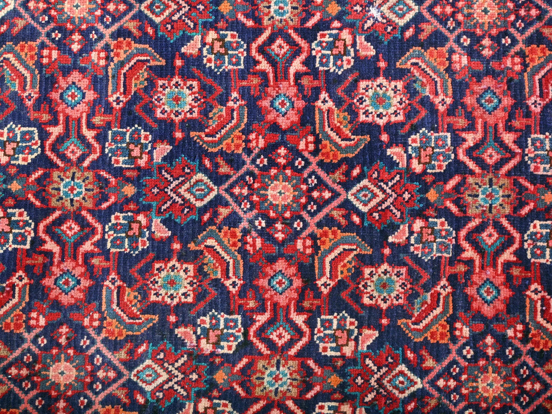 a red and blue rug with a pattern on it
