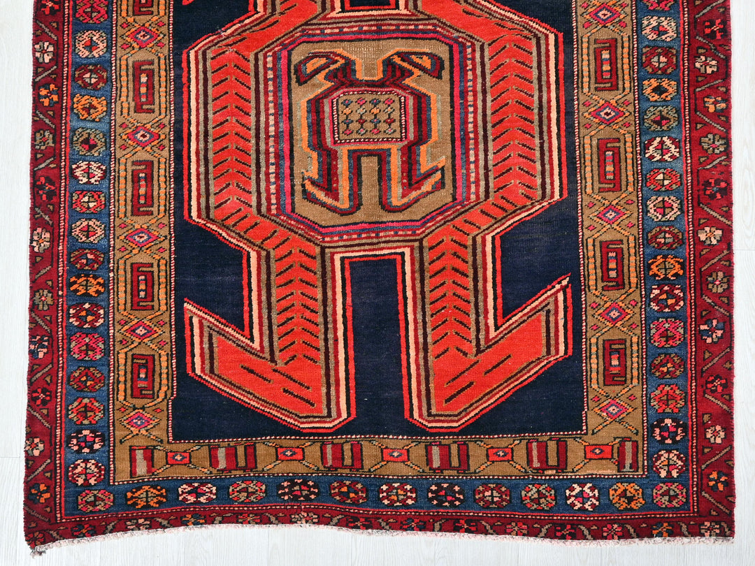 a red and blue rug with a design on it