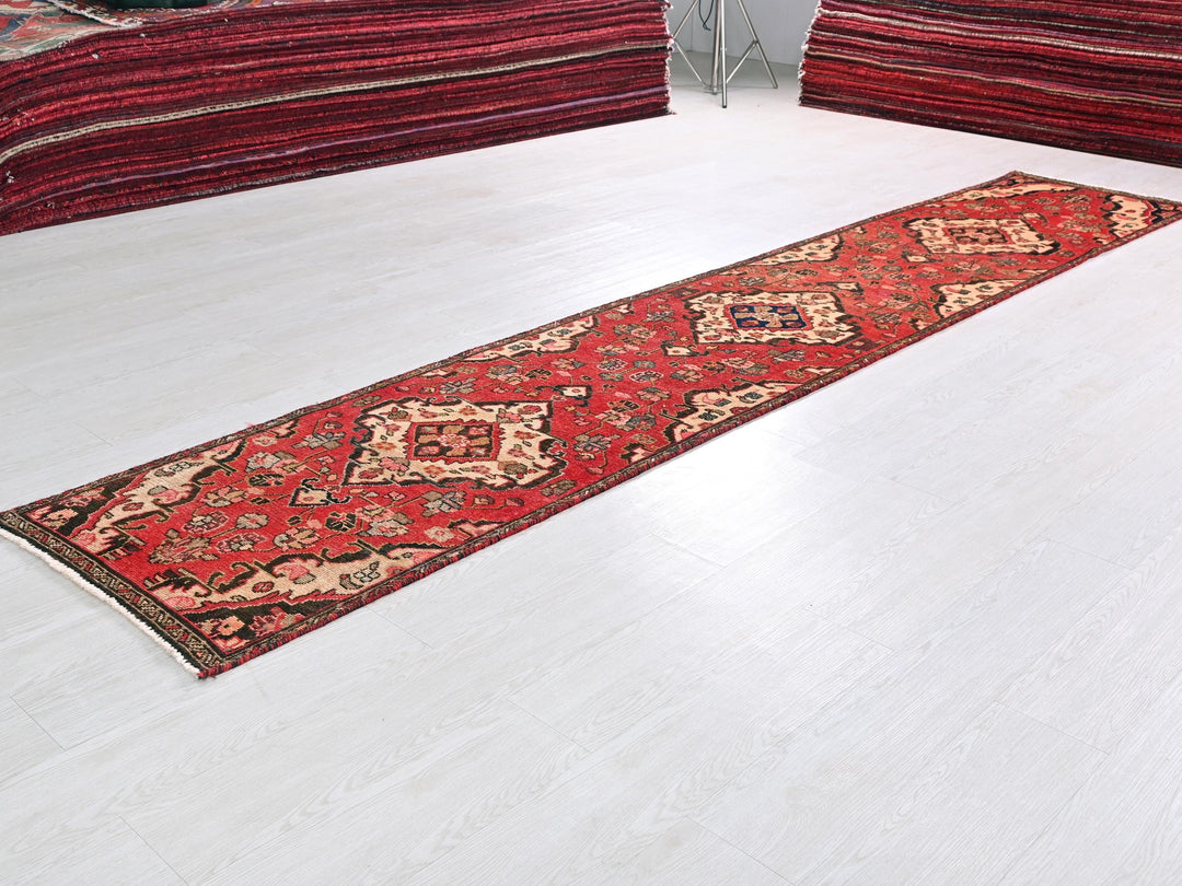 a red rug laying on a white floor
