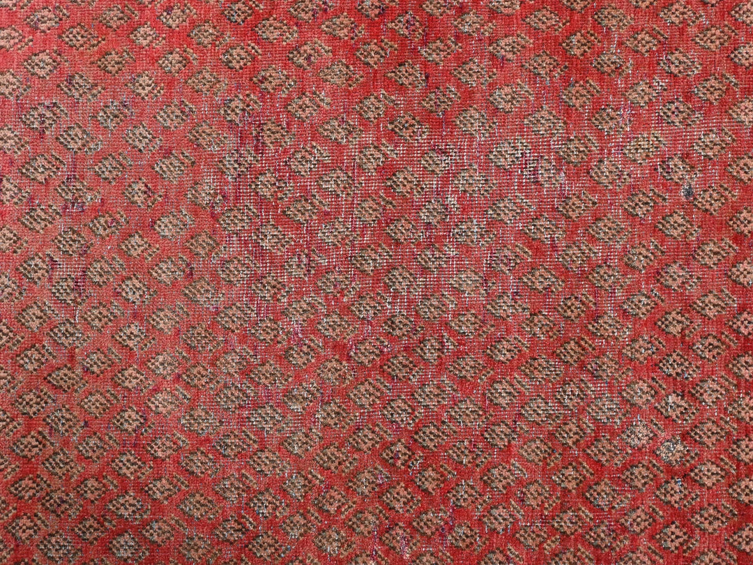 a close up of a red and brown rug