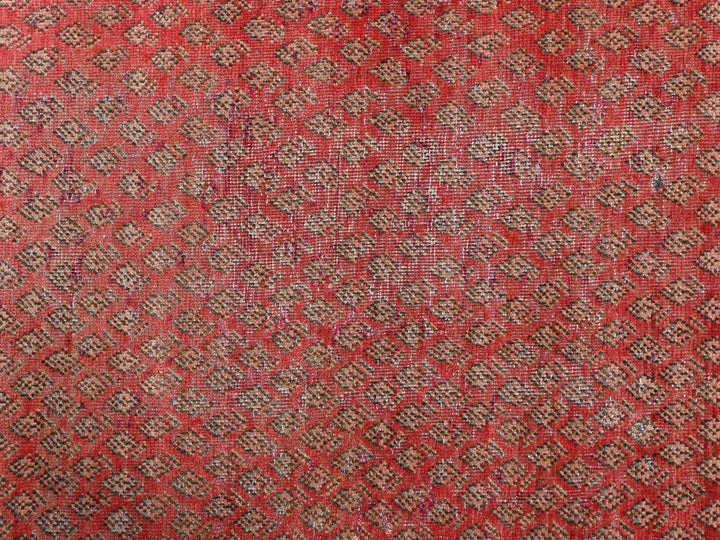 a close up of a red and brown rug